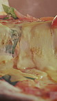 Closeup, baked and slice of pizza for takeaway, melted cheese and Italian recipe for fast food. Fresh, unhealthy or mozzarella with flatbread, traditional cuisine and gourmet takeout for hospitality
