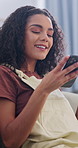 Coffee, phone and woman on sofa in home with peace, texting or calm morning on weekend. Happy, drinking and person with warm beverage and cellphone in living room for chatting or caffeine break.