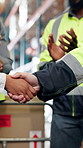People, logistics and success with handshake in warehouse for shipping or distribution partnership. Employees, colleagues or shaking hands with team applause in depot for supply chain, deal or b2b