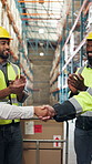 People, logistics and deal with handshake in warehouse for shipping or distribution success. Employees, colleagues or shaking hands with team applause in depot for supply chain partnership or b2b