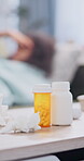 Pills, tissue and table with sick woman in home, healthcare and medication for illness with influenza headache. Antibiotics, drugs and prescription with toilet paper for person with allergies or pain