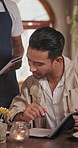 Menu, happy and customer with order in restaurant for food option, service or choice on weekend break. Man, waiter and person in cafe for diner selection, decision or breakfast request on holiday.