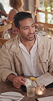 Menu, man and talking in restaurant on date for order choice, suggestion or communication. Person, customer and conversation at romantic dinner for main course, starter and fine dining options