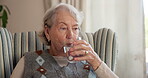 Old woman, drinking water and relax with glass in home, nutrition and digestion with liquid mineral. Retirement, wellness and elderly person with beverage for hydration, thirsty and detox in house