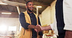 Carpenter, man and handshake in factory with deal, trust and manufacturing contractor agreement. Low angle, happy person and shaking hands in workshop with woodworker, discussion and collaboration.