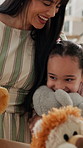 Happy mom, hug and child with teddy bear in home, connection and present for daughter in living room. Family, bonding and woman with gift, support and embrace with kid on weekend and love in house