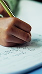 Hands, writing and child with homework in house for education, learning or practicing cursive. Book, student and kid studying for english subject with assignment, assessment or task in apartment.