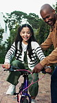Father, child and bicycle in driveway with help, training lesson and applause for learning success. Happy man, daughter and clap outdoor by home with bike, care and celebration for skill development.