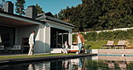 Parents, children and relax in backyard with soccer ball, swimming pool and family bonding together. Happy people, mother and father outdoor at home with kids, play football or chill on weekend break