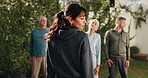 Fitness, trainer and people with outdoor class for senior wellness, health and shoulder shrug. Retirement group, instructor or workout with neck exercise for pilates, practice or training in backyard