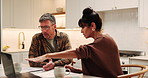 Laptop, couple or argument for budget in kitchen, wrong expenses or mortgage paperwork. Computer, mature man and woman with bills, financial conflict and pointing with disagreement for cost at home