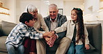 Happy, grandparents and hands together with children on sofa for teamwork, mission or bonding in home. Grandma, grandpa and kids piling with smile, stack or love for unity, trust or support in house