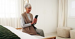 Senior, woman and reading in bedroom with phone, online and browsing website for retirement planning. Happy, elderly person and relax in house with tech, research and mobile app for life insurance.