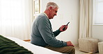Senior, man and smile in retirement home with phone, reading news and notification for text message. Happy, elderly person and browsing in bedroom with tech, social media post and digital article.