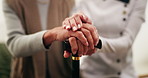 Holding hands, home and old woman with caregiver, cane and wellness in health community. Elderly person with a disability, support and retirement with walking stick for compassion or medical service