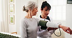 Caregiver, machine and old woman in retirement home for blood pressure test, medical advice or help. Senior person, healthcare worker and talk in bedroom with equipment, hypertension exam or support.