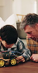 Boy, dad and toy car with cables in home for electrical engineering or remote control vehicle. Child, kid or learning with father to build robotic transportation for junior mechanic or development