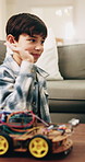 Son, dad and high five with toy car for engineering or remote control vehicle in home together. Boy, child or learning with father or success for robotic build for junior mechanic or development