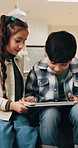 Children, tablet and playing together on home sofa with internet connection, education or gaming app. Boy, girl and technology with siblings or family while happy, learning and sharing in house