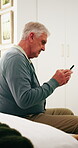 Phone, scroll and old man in retirement home with smile, social media and good news from text message. Happy, senior person and browsing in bedroom with tech, online chat and digital communication.