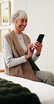 Phone, typing and old woman in retirement home with smile, social media or good news from text message. Happy, senior person and browsing in bedroom with tech, online chat and digital communication.