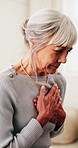 Sick, tired and old woman in house with chest pain, angina or heart attack symptoms for medical issue. Elderly person, health crisis or emergency with cardiac arrest, respiratory or breathing problem