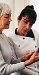 Senior, woman and doctor with glucometer in nursing home for monitoring glucose, test or exam. Female person, healthcare worker or elderly patient with blood sample for health examination in house