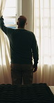 Back, old man and open curtains in bedroom for sunshine, wellness and wake up in home. Senior person, window and thinking in house for morning routine, mindset and reflection or calm in retirement