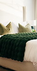 Hotel, bedroom and interior of empty room, hospitality service and luxury accommodation for travel. Bedding, pillow and motel or lodge with cozy blanket, comfort and resort design with furniture