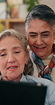 Tablet, mature and lesbian couple in home with discussion, planning holiday and booking flight ticket. Happy, lgbt women and talk in living room with tech, relationship and research for vacation.