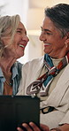 Tablet, mature and lesbian couple in house with love, browsing social media or people bonding together. Happy, lgbt women and talk in lounge with tech, internet connection and romantic relationship.