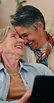 Tablet, mature and lesbian couple in home with laugh, bonding together and discussion for funny movie. Happy, lgbt women and talk in lounge with tech, relationship and humor for romantic comedy show.