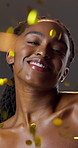 Beauty, confetti and face of black woman in studio for celebration, results or satisfaction. Glitter, glow and shine with funny person on dark background for achievement or skincare milestone