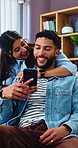Smile, couple and hug at house with phone, social media or browsing website for online shopping. People, laughing or embrace in home with mobile, comedy video and streaming subscription for ecommerce