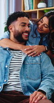 Hug, couple and love in living room with smile, bonding and gossip on sofa in apartment. Embrace, happy man and woman with communication in house with relationship, relax or chat in home with support