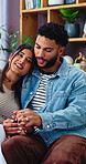 Holding hands, couple and love on sofa with smile, bonding and gossip in living room. Embrace, happy man and woman with communication in house with relationship, relax or chat in home with support