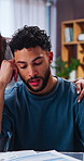 Stress, man and reading in home with documents, finance report and pressure of overdue expenses. Frustrated, couple and talk at house with paperwork, financial burden and debt problems for bankruptcy