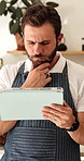 Waiter, man and thinking in restaurant with tablet, online order or confused for bad review on website. Server, person and problem solving in diner with tech, hospitality app or doubt for reservation