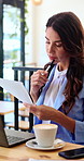 Cafe, laptop and business woman with documents, report and email marketing for media campaign. Coffee shop, paperwork and person on computer for research, communication strategy and remote work