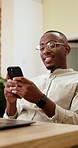 Phone, research and man with glasses in office, happy and planning for campaign on social media app. Creative, brand manager and black person with laptop, smile and digital marketing ads on mobile