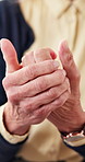 Hands, old person or pain in fingers with massage, arthritis complication or poor blood circulation. Retirement, elderly resident or closeup in home with joint ache, osteoporosis or chronic condition