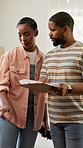 Checklist, planning and black couple in new home for bonding, renovation or maintenance together. Happy, ideas and man with woman with clipboard for property development of living room in apartment.
