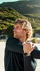 Fitness, man and stretching outdoor by beach for exercise preparation, wellness or thinking of workout. Active, male person and runner in nature with mountain, warm up and getting ready for training.