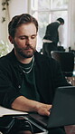 Business, laptop and typing with man in barbershop for agenda, online booking or schedule. Computer, review and startup career with serious person at hairdresser for management of digital calendar