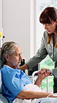 Family, old woman and holding hands in hospital with prayer, spiritual support and faith for surgery. Senior mother, adult daughter or praying in ward with sympathy, reassurance and medical operation