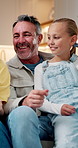 Talking, parents and laugh with kids in home for love, bonding together and family connection. Mother, father and funny girls in living room for storytelling, relax and smile with sisters on weekend