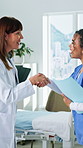 Smile, doctor and nurse in hospital with handshake, welcome or introduction for medical support. Happy, people and shaking hands in clinic for greeting, partnership and agreement for healthcare offer