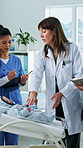 Doctor, nurses and baby doll in clinic for training, research and teamwork or management. Healthcare group, people and pediatrician mentor with child model for internship, collaboration or discussion
