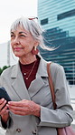 Mature, woman and thinking with phone in city for business travel, decision or choice. Female person, thoughtful employee or traveler contemplating with smartphone for commute or work trip in town