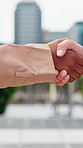 Business, people and city with handshake for meeting, introduction or partnership together. Employees, colleagues or shaking hands with deal, greeting or b2b for agreement or thank you in urban town